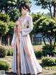 A woman in a white kimono standing in a garden.